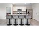 Bright kitchen with stainless steel appliances, white cabinets and a spacious island with bar stool seating at 523 Lazio Cir, Debary, FL 32713
