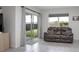 Cozy living area with comfortable seating, sliding glass doors to the backyard, and ample natural light at 523 Lazio Cir, Debary, FL 32713