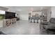 Spacious open-concept living area featuring modern furnishings, a kitchen island, and tile flooring throughout at 523 Lazio Cir, Debary, FL 32713