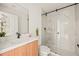Modern bathroom with a large walk-in shower, floating vanity, and elegant tile at 6113 Chorus Dr, Mascotte, FL 34753