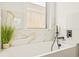 Relaxing bathroom with a soaking tub and marble tile at 6113 Chorus Dr, Mascotte, FL 34753