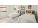 Bright bedroom with twin beds, shelving, and playful decor at 6113 Chorus Dr, Mascotte, FL 34753