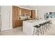 Modern kitchen with white quartz countertops and wood cabinets at 6113 Chorus Dr, Mascotte, FL 34753