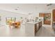Open concept kitchen with island, wood cabinets, and stainless steel appliances at 6113 Chorus Dr, Mascotte, FL 34753