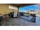 Screened lanai with pool, lounge chairs, and outdoor kitchen at 7613 Wandering Way, Orlando, FL 32836