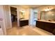 Spacious bathroom with double vanity, walk-in shower, and large closet at 7613 Wandering Way, Orlando, FL 32836