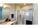 Bathroom with a large shower, vanity with modern fixtures, and a linen towel rack at 7613 Wandering Way, Orlando, FL 32836