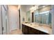 Double vanity bathroom with a large shower and a separate toilet at 7613 Wandering Way, Orlando, FL 32836
