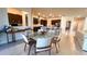 Modern dining room with round glass table and light beige chairs at 7613 Wandering Way, Orlando, FL 32836