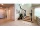 Elegant entryway with staircase, tile floors, and natural light at 7613 Wandering Way, Orlando, FL 32836