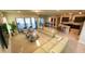Open living room and kitchen with beige sofas, modern furniture, and pool view at 7613 Wandering Way, Orlando, FL 32836