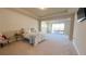 Large main bedroom with sliding glass doors leading to a balcony at 7613 Wandering Way, Orlando, FL 32836