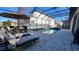 Relaxing pool area with patio furniture and screened enclosure at 7613 Wandering Way, Orlando, FL 32836