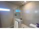 Walk-in shower with glass enclosure and built-in shelving at 7613 Wandering Way, Orlando, FL 32836