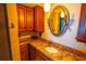 Bathroom vanity with granite countertop and large mirror at 7616 Spring Bay Cv # S, Orlando, FL 32819