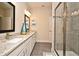 Bathroom showcasing a glass shower, long vanity with granite countertops, and neutral color palette at 7958 Delwin Ln, Kissimmee, FL 34747