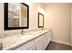 Double vanity bathroom with granite countertop and large mirrors at 7958 Delwin Ln, Kissimmee, FL 34747