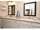 Bathroom with double sinks, granite countertops, and framed mirrors at 7958 Delwin Ln, Kissimmee, FL 34747