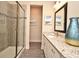 Bathroom featuring a glass shower, granite countertop, and stylish blue vase at 7958 Delwin Ln, Kissimmee, FL 34747