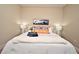 Cozy bedroom showcasing a well-made bed with decorative pillows, lamps, and a stylish rug at 7958 Delwin Ln, Kissimmee, FL 34747