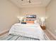 Comfortable bedroom showcasing a well-made bed with decorative pillows and a stylish rug at 7958 Delwin Ln, Kissimmee, FL 34747