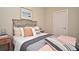 Bedroom featuring a bed, side table, neutral decor and lots of pillows at 7958 Delwin Ln, Kissimmee, FL 34747