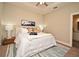 Bedroom featuring a well-made bed with decorative pillows and a stylish rug; ceiling fan included at 7958 Delwin Ln, Kissimmee, FL 34747