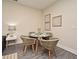 Cozy dining area features a round table with seating for four, accented by modern wall art at 7958 Delwin Ln, Kissimmee, FL 34747