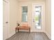 Bright entryway features stylish door with glass insert, neutral walls, and wood-look floors at 7958 Delwin Ln, Kissimmee, FL 34747