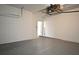 Garage with white block walls and grey epoxy flooring at 7958 Delwin Ln, Kissimmee, FL 34747