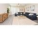 Bright living room with wood floors, a stylish rug, and a comfortable sofa and modern decor at 7958 Delwin Ln, Kissimmee, FL 34747