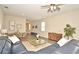 Bright and airy living room with an open floor plan, connecting the dining area and kitchen at 7958 Delwin Ln, Kissimmee, FL 34747