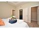 Comfortable main bedroom showcasing a well-made bed, closet doors, and neutral decor at 7958 Delwin Ln, Kissimmee, FL 34747