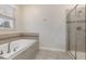 Bathroom with soaking tub and walk-in shower at 8828 Cruden Bay Ct, Davenport, FL 33896