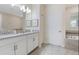 Modern bathroom with double sinks and a soaking tub at 8828 Cruden Bay Ct, Davenport, FL 33896