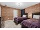 Harry Potter bedroom with two twin beds and brick wall at 8828 Cruden Bay Ct, Davenport, FL 33896