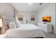 King-size bed, large TV, and ensuite bathroom access at 8828 Cruden Bay Ct, Davenport, FL 33896