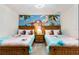 Twin bedroom with Moana mural and two comfortable beds at 8828 Cruden Bay Ct, Davenport, FL 33896
