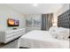 King-size bed, large TV, and modern decor at 8828 Cruden Bay Ct, Davenport, FL 33896