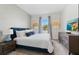 Spacious bedroom with a king-size bed and a large TV at 8828 Cruden Bay Ct, Davenport, FL 33896