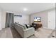 Cozy bonus room features a comfy sofa and large TV, perfect for relaxation at 8828 Cruden Bay Ct, Davenport, FL 33896