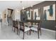 Elegant dining room with glass table, modern chairs, and abstract art at 8828 Cruden Bay Ct, Davenport, FL 33896