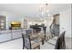 Open concept dining area with glass table and view into living room and kitchen at 8828 Cruden Bay Ct, Davenport, FL 33896