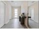 Bright entryway with tile flooring, console table, and 3D wall accent at 8828 Cruden Bay Ct, Davenport, FL 33896