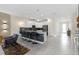 Modern kitchen with white cabinets, gray countertops, and island with seating at 8828 Cruden Bay Ct, Davenport, FL 33896