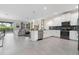 Open concept kitchen with island, stainless steel appliances, and view of living room at 8828 Cruden Bay Ct, Davenport, FL 33896