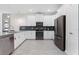 Modern kitchen with stainless steel appliances and dark gray tile backsplash at 8828 Cruden Bay Ct, Davenport, FL 33896