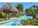 Relaxing lazy river with inner tubes, shaded seating, and lush landscaping at 8828 Cruden Bay Ct, Davenport, FL 33896