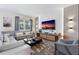 Spacious living room featuring a sectional sofa, large TV, and accent chair at 8828 Cruden Bay Ct, Davenport, FL 33896