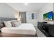 Bright main bedroom with a king-size bed and stylish dresser at 8828 Cruden Bay Ct, Davenport, FL 33896